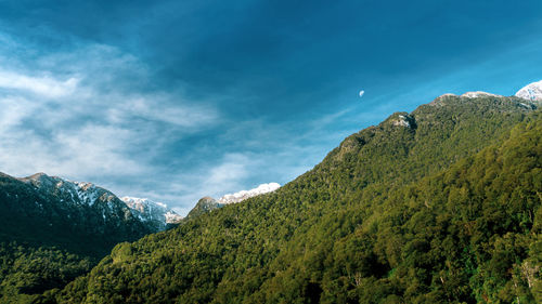 Scenic view of mountains against blue sky