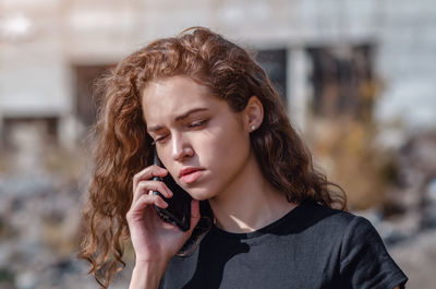 Urban communication beautiful young woman talking on phone outdoors
