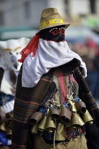 Close-up of man wearing hat and bells