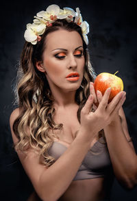 Portrait of beautiful woman holding an apple