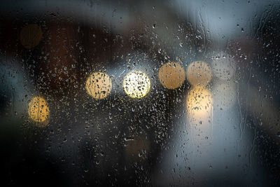 Full frame shot of wet glass window in rainy season