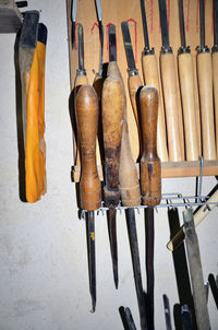 Close-up of clothes hanging on wood against wall