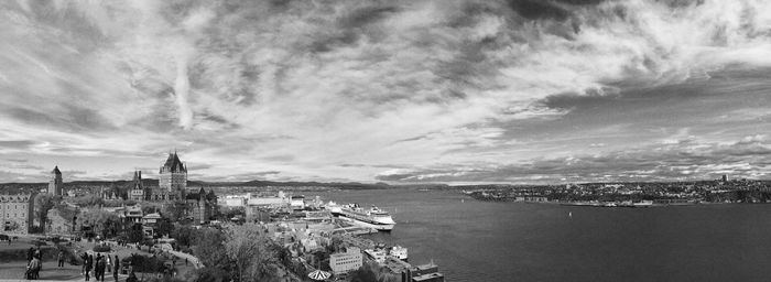 Panoramic view of city against cloudy sky