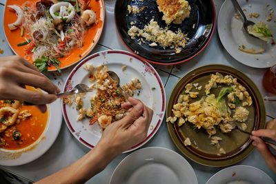 High angle view of person eating food on table