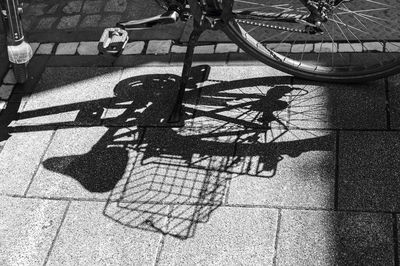 High angle view of shadow of bicycle on street