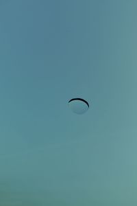 Close-up of water drop against blue sky