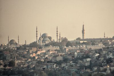 View of buildings in city against clear sky