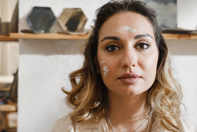 Close-up dirty woman potter portrait, self-employed pottery artist in creative studio working 