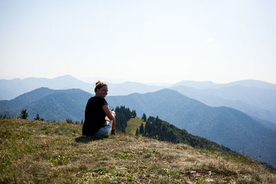 Man standing on mountain against clear sky