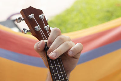 Cropped hand of man playing guitar