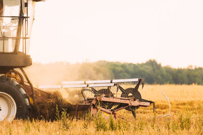 Tractor on field against clear sky