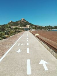 Road by mountain against clear sky