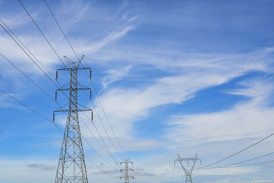 High voltage power transmission tower and sky background