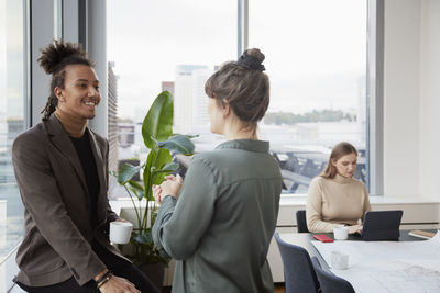 Man and woman talking in office