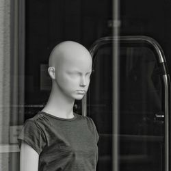 Mannequin seen through store window