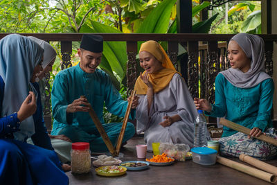 Group of people sitting on table