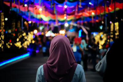 Rear view of woman with multi colored lights