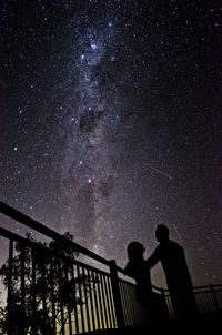 Silhouette of couple under starry sky