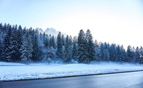 Scenic view of snow covered land against clear sky