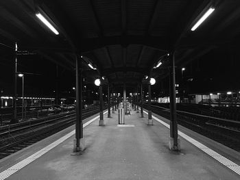 Empty railroad station platform at night