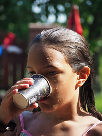 Close-up portrait of a woman drinking water