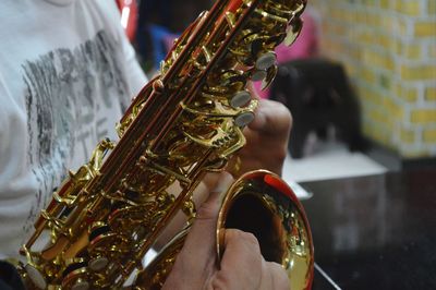 Midsection of saxophonist playing saxophone