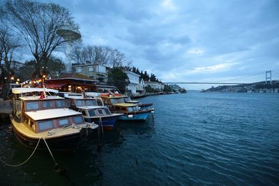 Boats in river with buildings in background