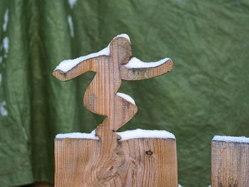 Close-up of wooden post on fence during winter