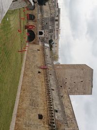 High angle view of construction site by road against sky