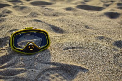 High angle view of sunglasses on beach