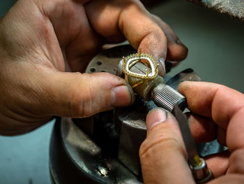 Close-up of hand making jewelry