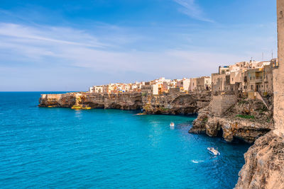 Scenic view of polignano a mare in apulia in italy against dramatic sky