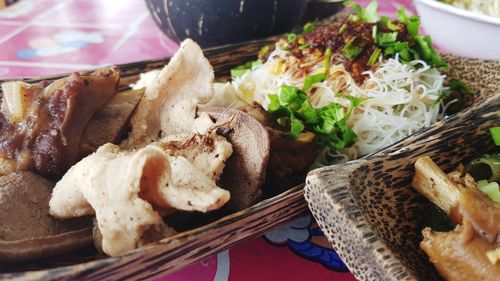 Pork and entrails boil and cooked served in wooden rectangle bowls