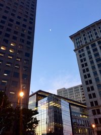 Low angle view of illuminated buildings against sky at night