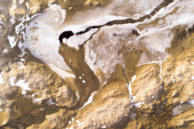 Close-up of sand beach covered partially with snow during winter in the arctic