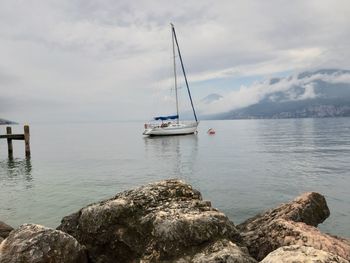 Sailboat sailing on sea against sky