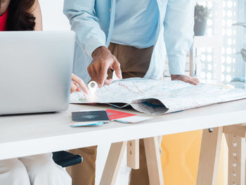 Midsection of business colleagues working at office