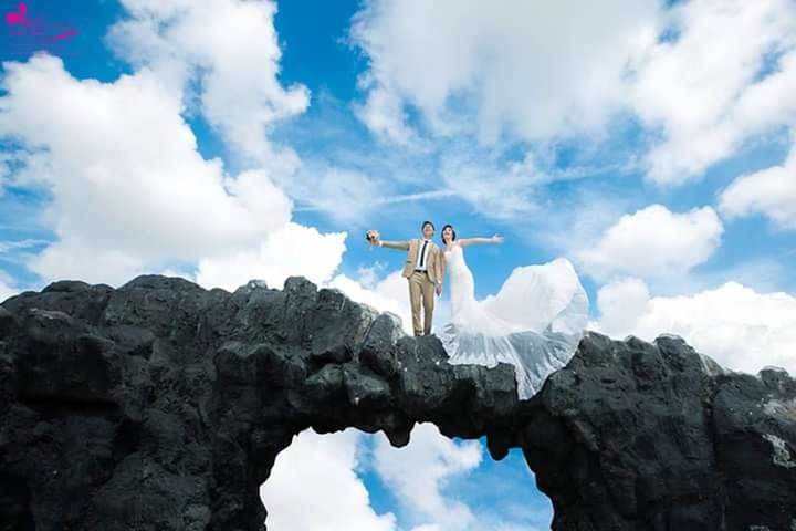 cloud - sky, sky, low angle view, day, nature, solid, rock, rock - object, religion, belief, standing, spirituality, white color, people, sculpture, adult, outdoors, blue, statue