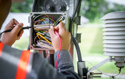 Cropped hand of man holding equipment