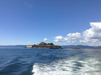 Scenic view of sea against blue sky