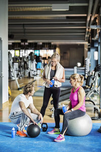 Friends conversing at gym