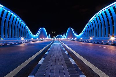 Illuminated light trails on road at night