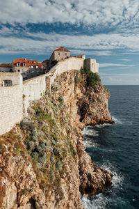 Scenic view of fort by sea against sky