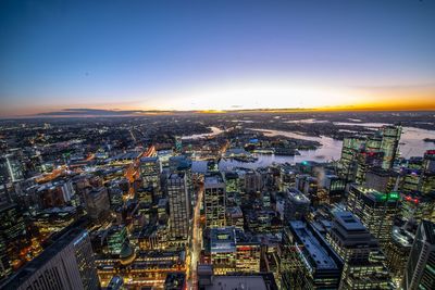 High angle view of illuminated cityscape against sky during sunset