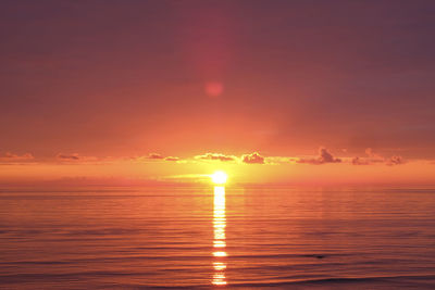 Scenic view of sea against orange sky