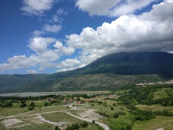 Scenic view of landscape and mountains against sky