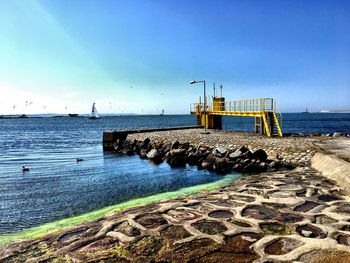 Scenic view of beach against blue sky