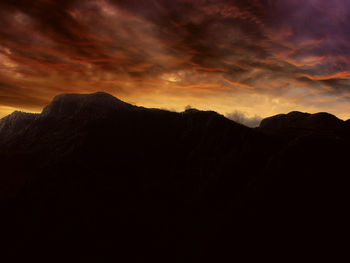 Scenic view of mountains against dramatic sky