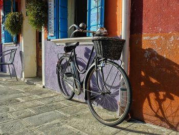 Bicycle parked against brick wall