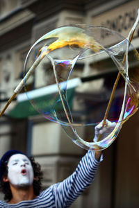 Close-up portrait of woman with bubbles in background